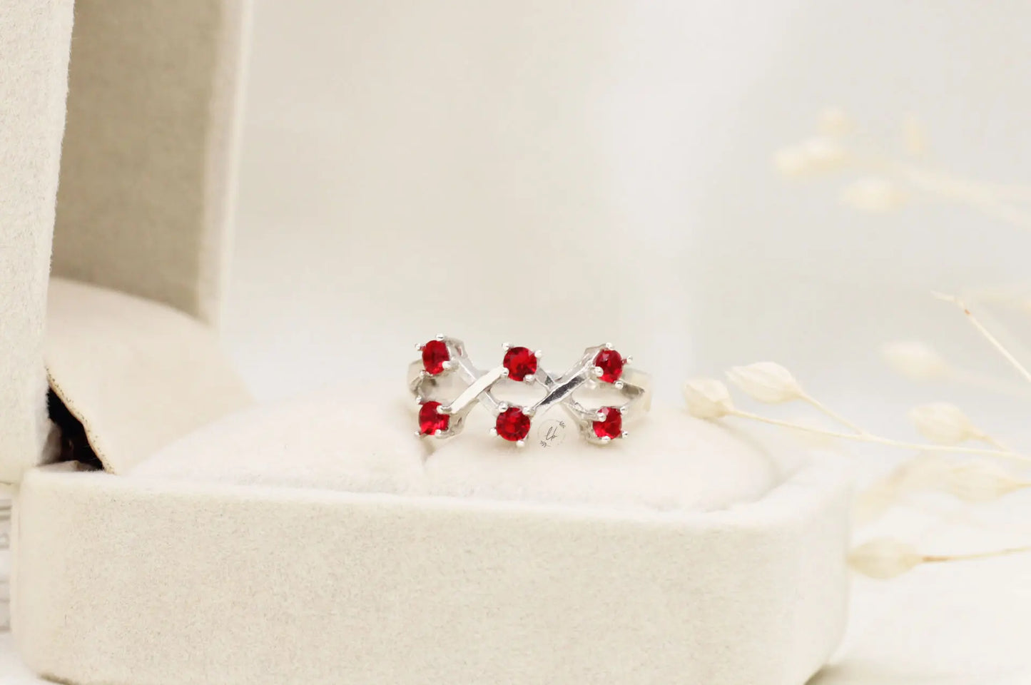 Exquisite Sterling Silver and Ruby Crossed Band Ring – A Touch of Sophistication